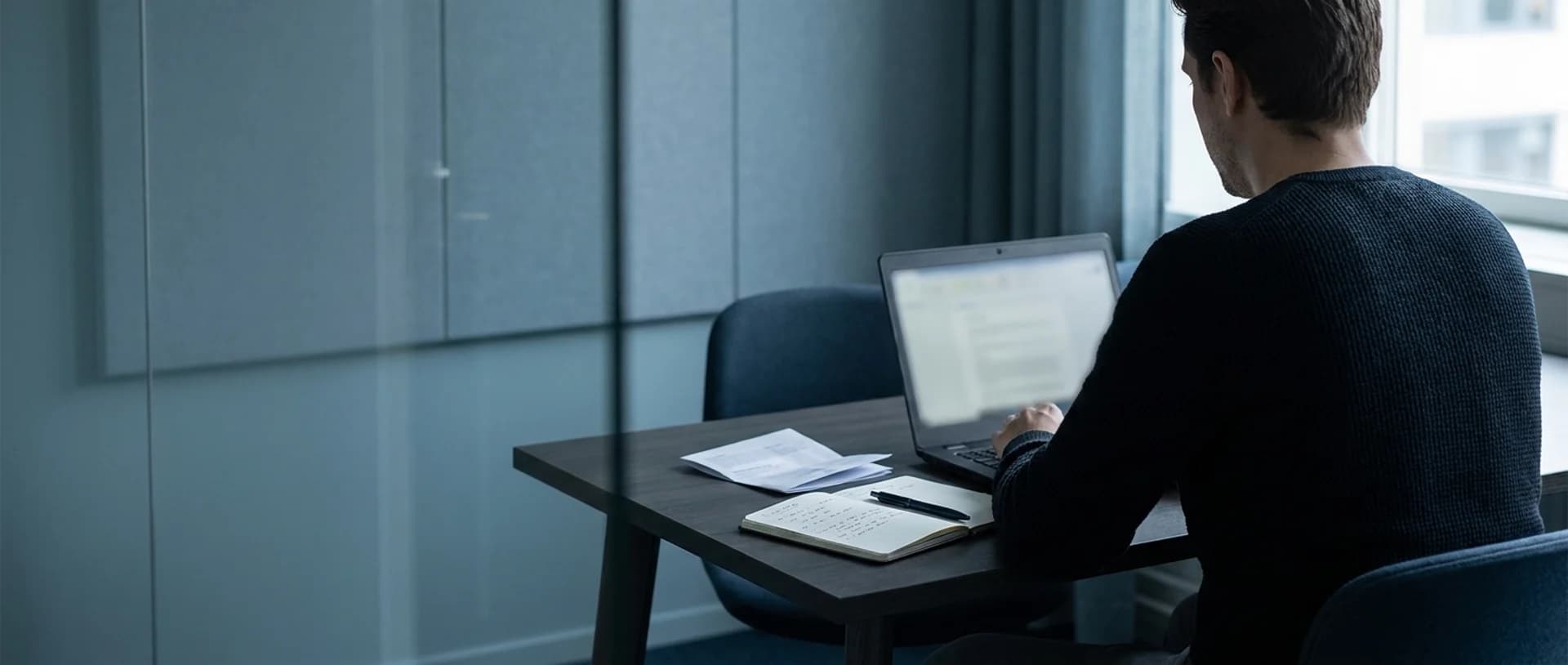 An operator working in a calm office at dusk